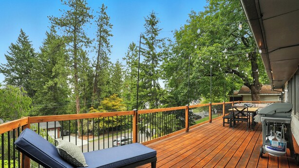A wooden deck with a lounge area, outdoor furniture, and a grill. - The South Perry Perch ~ 5BD Family Retreat (Spokane)