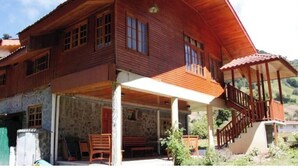 A wooden house with a balcony and a covered porch. - Cabin in Cerro Punta  6BR, Fireplace, Hiking (Cerro Punta)