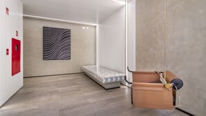 A modern room with a hanging swing, a bed, and a large abstract painting on the wall. - 360 Pamplona NR  (São Paulo)