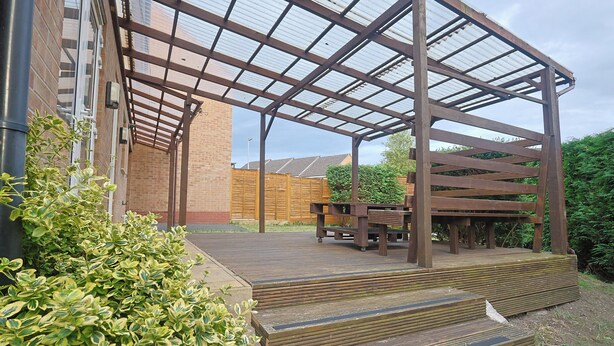 A covered outdoor area with wooden steps leading up to a bench. - Manchester 3-beds, Sleeps 6 With On-site Parking (Manchester)
