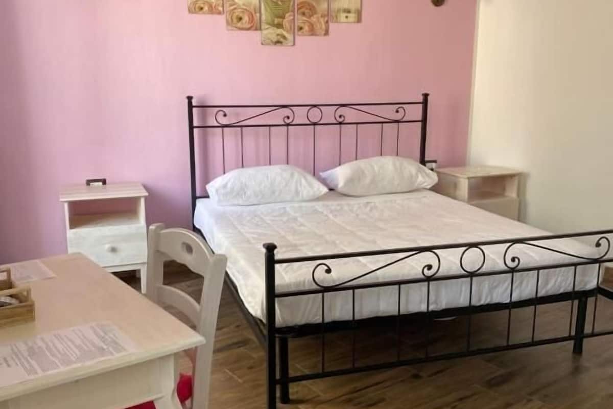 Ein Schlafzimmer mit Bett, Schreibtisch und Stuhl.