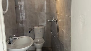 A small bathroom with a sink, toilet, and shower. - House of la Marsa (La Marsa)