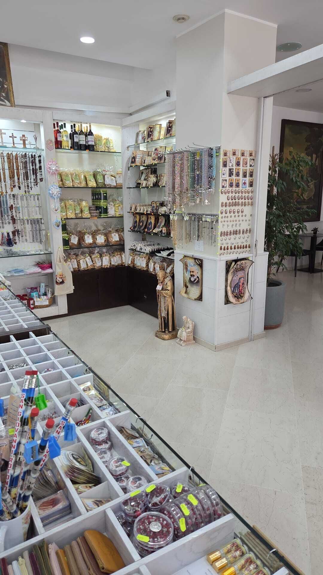 A store with shelves of jewelry, a statue, and various items on display.