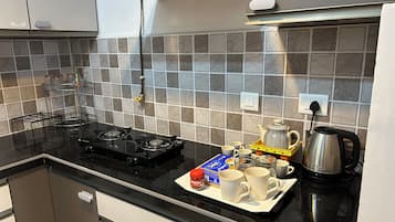 Fridge, stovetop, electric kettle, cookware/dishes/utensils