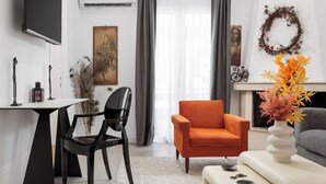 A modern living room with a flat-screen TV, a dining table with chairs, a sofa, and a decorative vase. - Hera Family Apartment, Olympian Zeus Apartments (Athens)