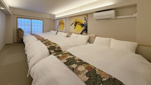 A hotel room with two beds, a large window, and artwork on the wall. - bHotel Miyajima Omotesando 21 (Hatsukaichi)