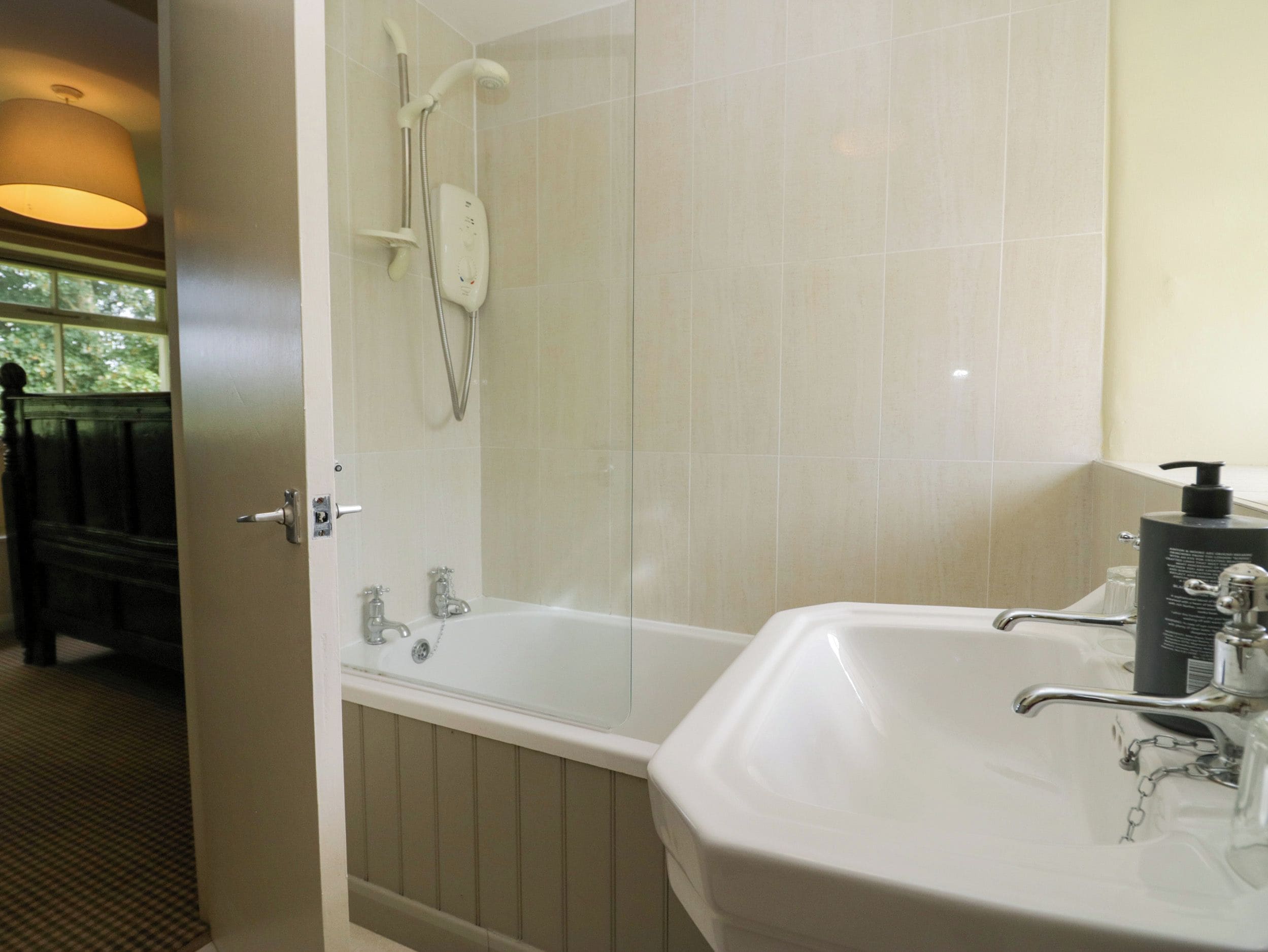 A bathroom with a bathtub, a shower, and a sink.