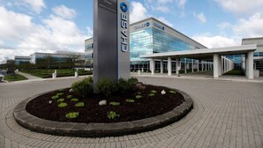 A modern Chase bank building with a prominent sign and a landscaped area in front. - Top Floor Water View King Bed Pool Gym (Westerville)