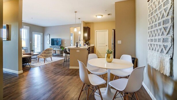 A modern kitchen with a central island, white chairs, and a dining table. - Lux Dublin 2BR 1st Floor W D Pet Friendly (Dublin)