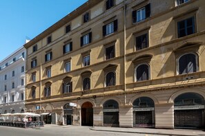 A multi-story building with arched windows and a ground-level entrance. - Laura Roof Terrace Teatro dell'Opera (Roma)