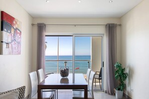 A dining area with a table, chairs, a bowl, and a potted plant.