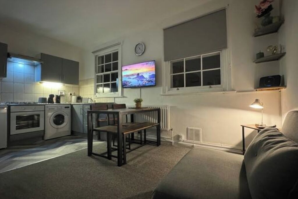 A compact living space with a kitchenette, a dining area, and a seating area.