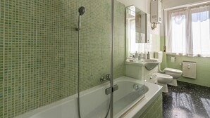 A bathroom with a shower, a bathtub, a sink, and a toilet. - GuestHost - Cozy 75 sqm apartment, perfect for four people, located on the fourth floor of a building with an elevator (NOT wheelchair accessible).The property is located in a well-served residential neighborhood, just a short public transportation ride  (La Spezia)