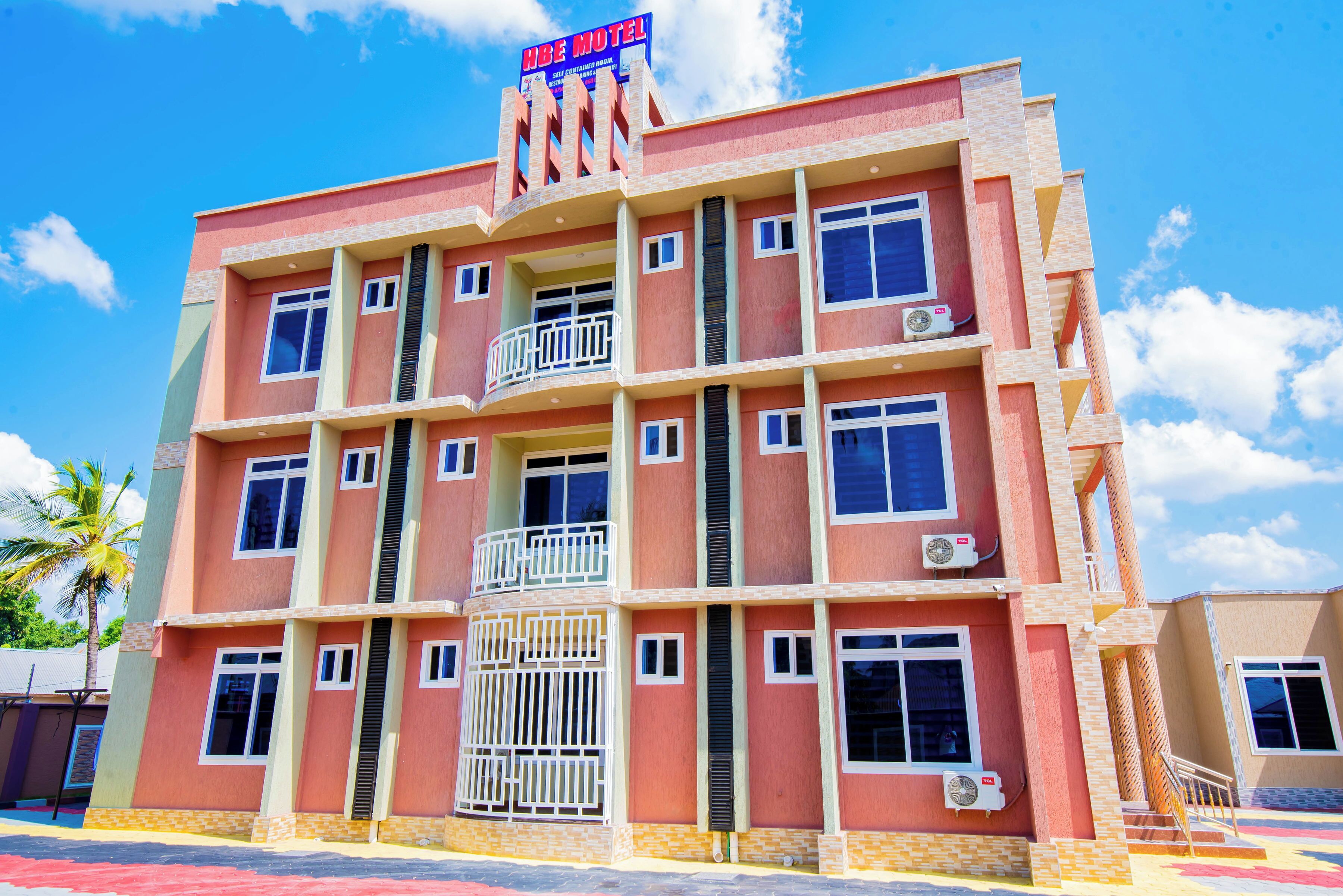 A multi-story motel with balconies and air conditioning units.
