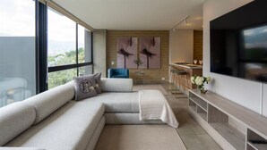 A modern living room with a sectional sofa, a flat-screen TV, and artwork on the wall. - Perfect home in Medellín 501 (Medellín)
