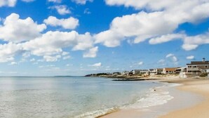 A beach with clear skies and a calm sea. - Eazy Breezy Beach Home (Dennis)
