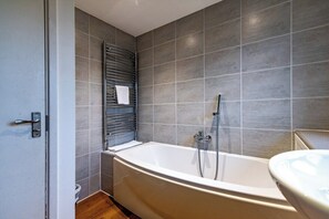A modern bathroom with a freestanding bathtub, a towel rack, and a toilet. - CircleWay Homes - Nuthall (Nuthall)