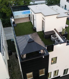 A modern building with a rooftop pool, a covered patio, and a small garden area. - Large Groups - 2mi. from Downtown (Nashville)