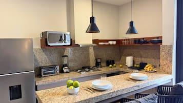 Classic Studio, 1 King Bed, Balcony | Private kitchen | Full-sized fridge, microwave, stovetop, cookware/dishes/utensils