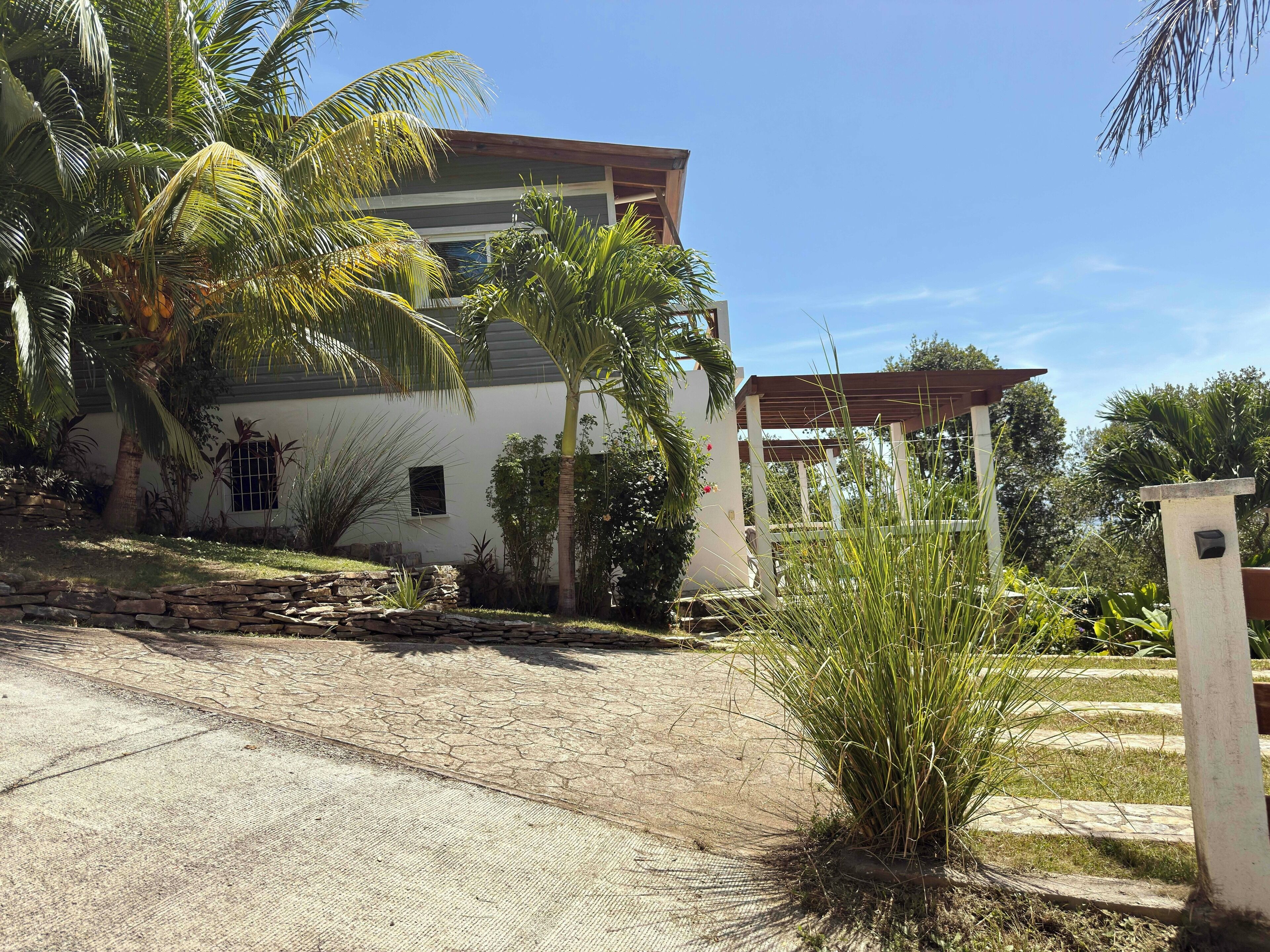 A modern building with a stone pathway leading to a gated entrance.