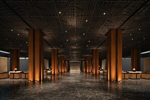 A spacious lobby with high ceilings, large wooden columns, and a polished marble floor. - The Meru Sanur (Denpasar)