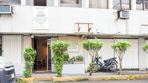 A commercial space with a sign for 'Victoria Mansions' and a parked motorcycle.