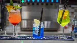 Three drinks on a bar counter with a blurred background. - Club Esse Aquilia Beach Village (Badolato)