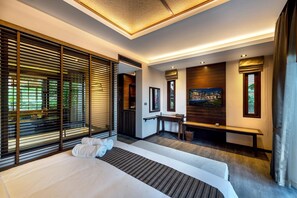 A modern hotel room with a large bed, a desk, and a TV. - Nirvana Beach Resort (Ko Lanta)