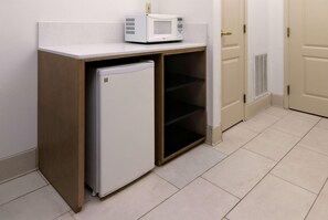 A compact kitchenette with a microwave and a small refrigerator. - Wyndham Garden Mcallen at La Plaza Mall (McAllen)