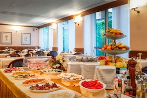 A buffet setup with various food items and a fruit display. - Hotel Crivi's (Milan)