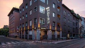 A modern hotel building with multiple floors and a prominent sign. - Hotel Crivi's (Milan)