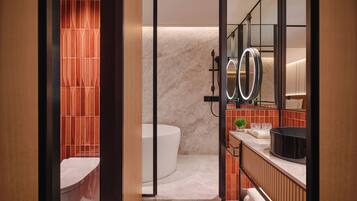 A modern bathroom with a bathtub, a large mirror, and a vanity with a sink and countertop.