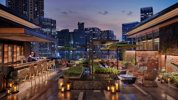 A rooftop bar with seating and a view of the city skyline at dusk. - Hyatt Centric The Ring Chengdu (Chengdu)