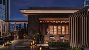 A modern outdoor seating area with a bar, potted plants, and ambient lighting. - Hyatt Centric The Ring Chengdu (Chengdu)