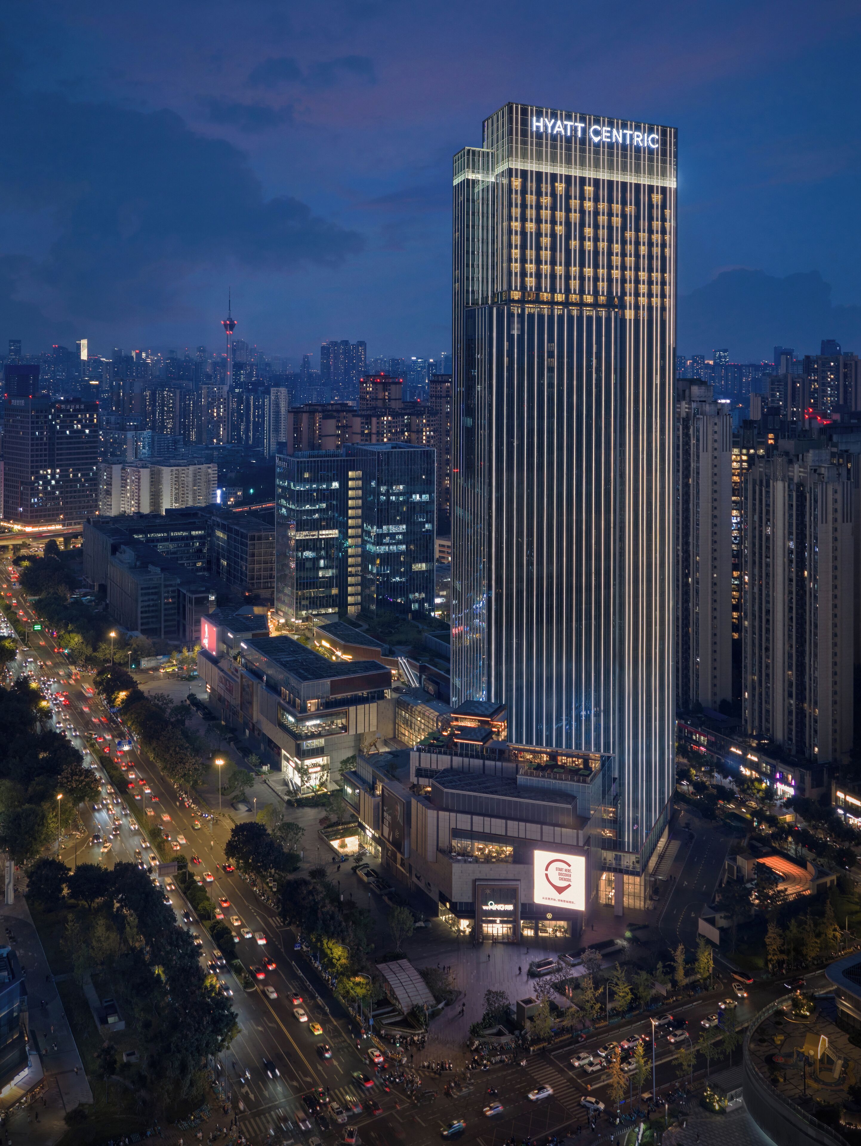 A high-rise hotel with a modern design, featuring a prominent "HYATT CENTRIC" sign at the top.