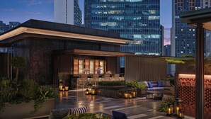 A rooftop bar with outdoor seating, a bar area, and a view of city buildings. - Hyatt Centric The Ring Chengdu (Chengdu)