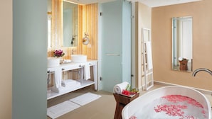A modern bathroom with two sinks, a bathtub with rose petals, a towel rack, and a mirror. - Azul Beach Resort Negril By Karisma (Negril)