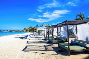 A beachside resort with overwater bungalows, clear blue skies, and a sandy beach. - Azul Beach Resort Negril By Karisma (Negril)