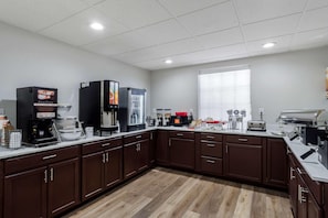 A modern kitchen with a coffee station, microwave, toaster, and a large window. - Comfort Inn & Suites Lexington South (Lexington)