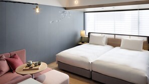 A hotel room with a bed, a sofa, a table with cups and a tray, and a window with blinds. - Good Nature Hotel Kyoto (Kyoto)