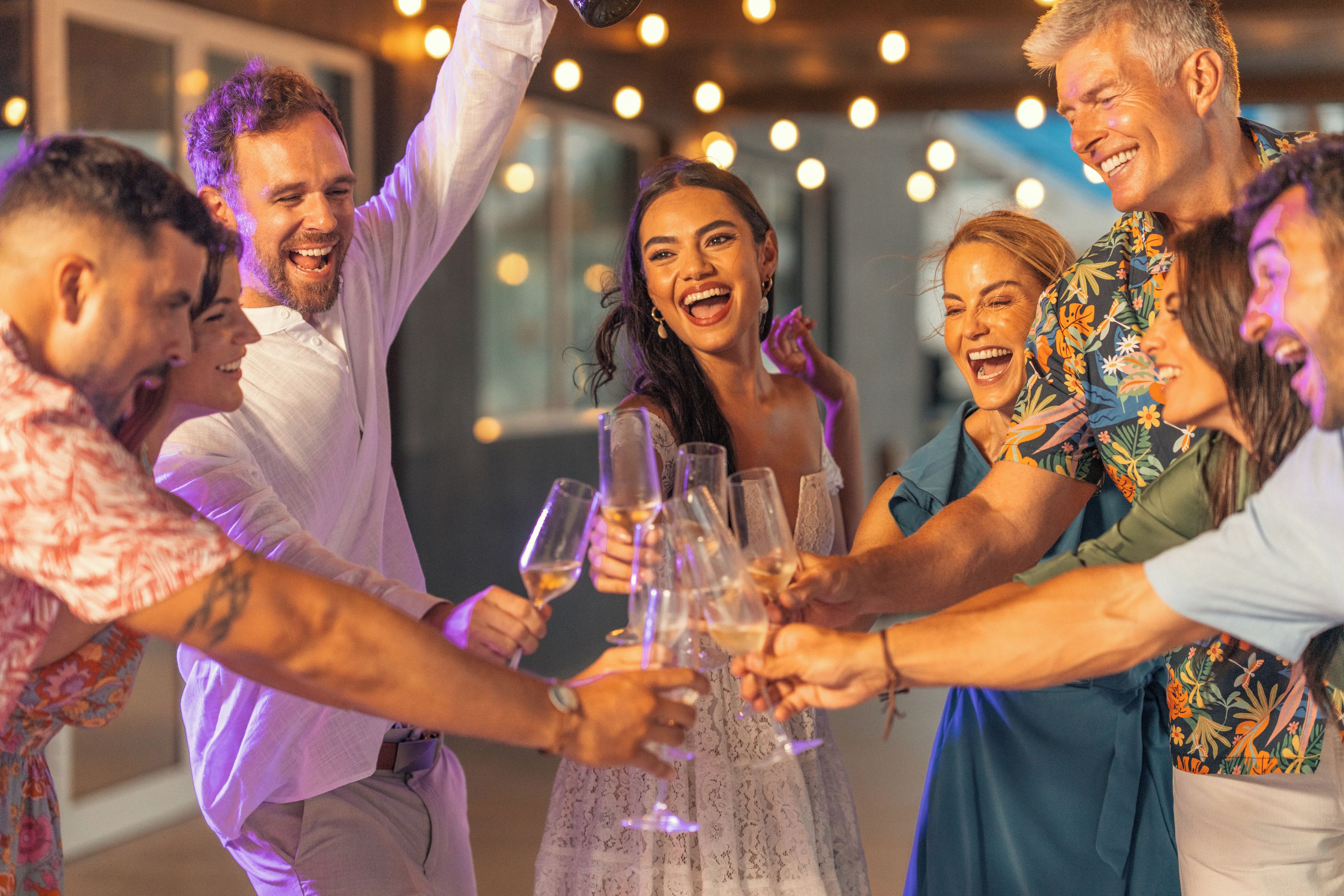 Un groupe de personnes trinquant avec des coupes de champagne.