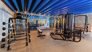 A gym with various exercise equipment, including weight machines and dumbbells. - Margaritaville Island Reserve Riviera Maya (Puerto Morelos)