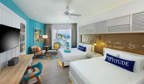 A hotel room with a large bed, a desk, a chair, a TV, and a view of the ocean. - Margaritaville Island Reserve Riviera Maya (Puerto Morelos)