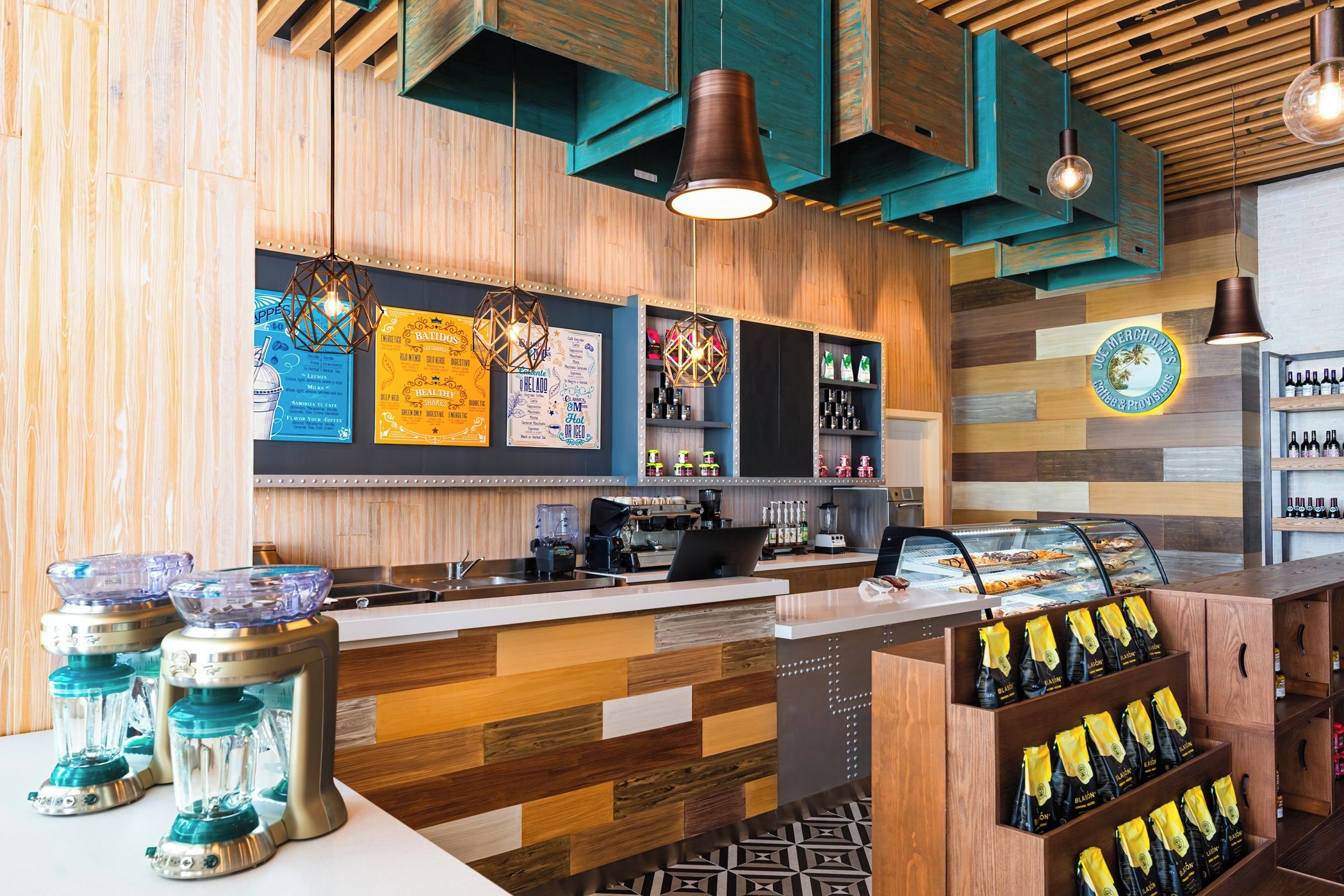 A bar area with wooden paneling, a coffee machine, and a display of bottled beverages.
