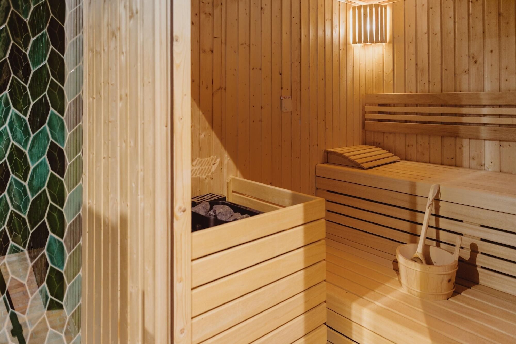 A wooden sauna with benches and a bench with a backrest.