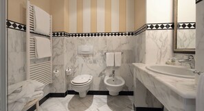 A bathroom with a toilet, bidet, and sink, all with marble countertops. - Hotel Cannero (Cannero Riviera)