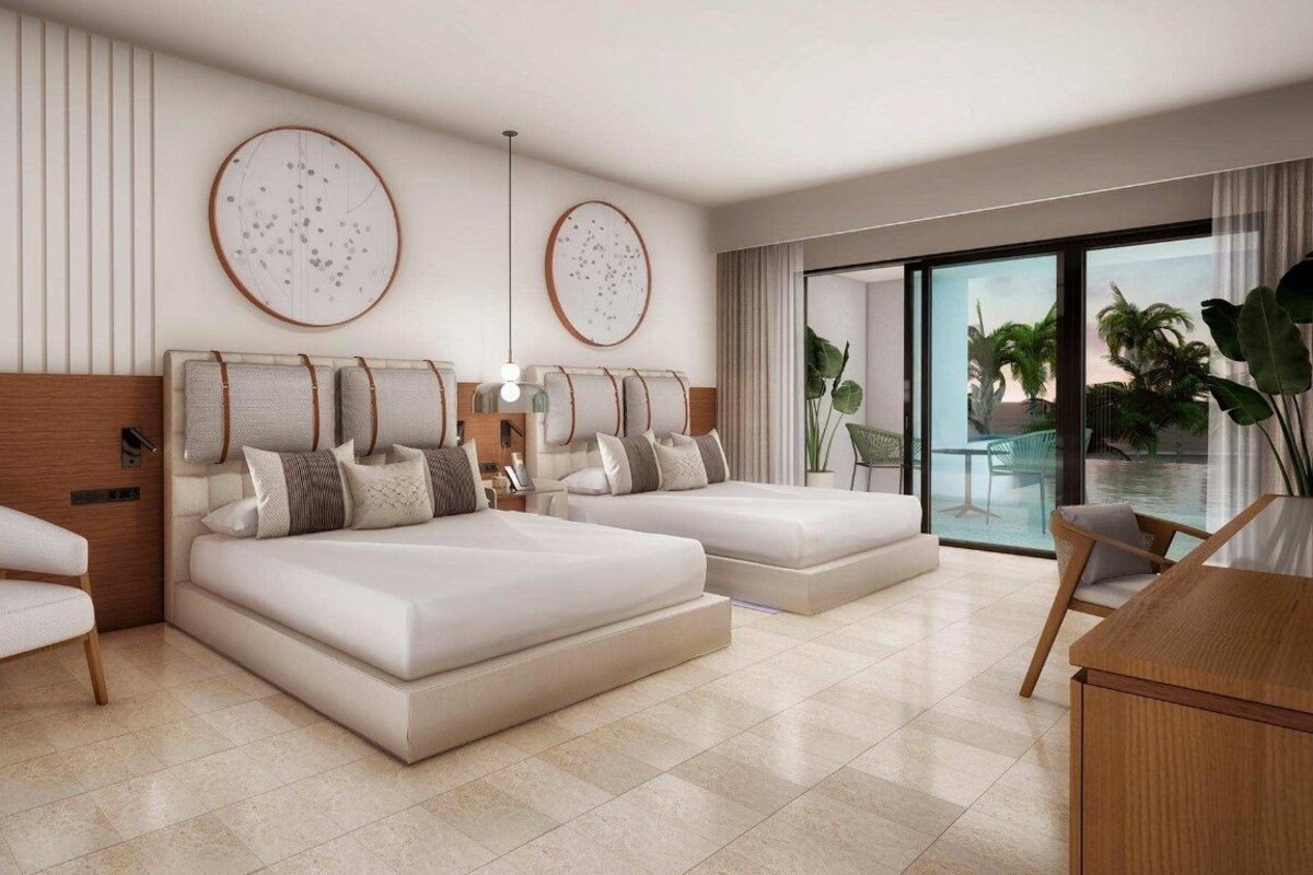 Une chambre moderne dotée d’un grand lit, d’un coin salon et offrant une vue sur l’extérieur.