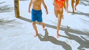 A sandy beach with palm trees and people walking. - Family Selection At Grand Palladium Kantenah (Kantenah)
