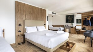 A modern hotel room with a large bed, a desk, a chair, and a wardrobe. - B&B Hotel Passo Tre Croci Cortina (Cortina d'Ampezzo)
