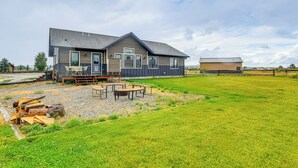 A modern house with a large deck, outdoor seating, and a well-maintained lawn. - Pinedale Getaway Near Hiking, Skiing & Lakes! (Pinedale)